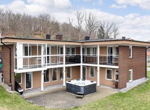 a large brick building with a hot tub on a patio at Ronneby Torneryd Retreat in Ronneby