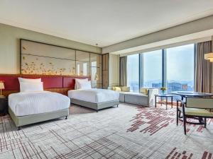 Voodi või voodid majutusasutuse Pullman Huizhou Kaisa toas