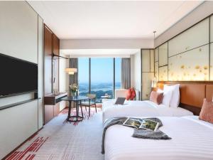 Voodi või voodid majutusasutuse Pullman Huizhou Kaisa toas