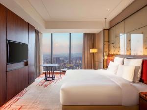 Voodi või voodid majutusasutuse Pullman Huizhou Kaisa toas