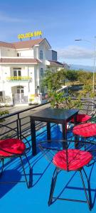 a table and two red chairs sitting on a patio at Hải Nam Homestay Cam Lâm in Cam Lâm