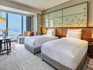 Voodi või voodid majutusasutuse Pullman Huizhou Kaisa toas