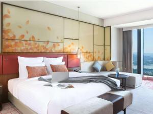 Voodi või voodid majutusasutuse Pullman Huizhou Kaisa toas