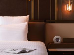 Voodi või voodid majutusasutuse Pullman Huizhou Kaisa toas