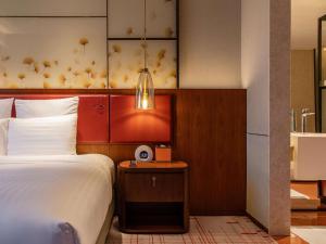 Voodi või voodid majutusasutuse Pullman Huizhou Kaisa toas