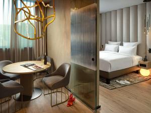 A bed or beds in a room at The Emporium Hotel Plovdiv - MGallery Collection