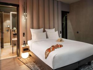 A bed or beds in a room at The Emporium Hotel Plovdiv - MGallery Collection