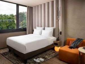 A bed or beds in a room at The Emporium Hotel Plovdiv - MGallery Collection