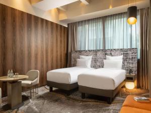 A bed or beds in a room at The Emporium Hotel Plovdiv - MGallery Collection