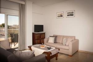 a living room with a couch and a tv at Port House in Rhodes Town
