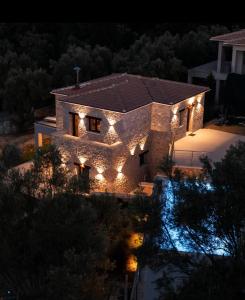 a house with lights on it at night at Orraon Luxury Villa in Lefkada Town