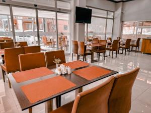 a dining room with tables and chairs and a television at Oreko Express in Afyon