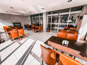 a restaurant with orange chairs and tables and a bar at Oreko Express in Afyon