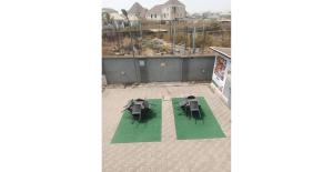 an overhead view of two tables and chairs on a roof at Angels Court Hotel and Suite in Kubwa