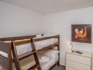 a bedroom with a bunk bed with a ladder and a desk at Appartement Richemont 106 in La Tzoumaz +5 photos