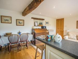 a kitchen and living room with a table and chairs at Castle House Cottage in Kirkby Stephen