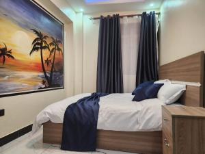 Postel nebo postele na pokoji v ubytování EQUATOR SUITES -KAMPALA -Ivory Mall -Bunga Gaba Road