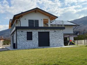 a house with a balcony on top of a yard at Nongole 305 in Faverga