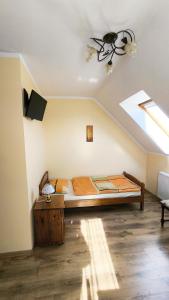 a bedroom with a bed and a skylight at Jaś i Małgosia nad Jeziorem Wigry in Rosochaty Róg