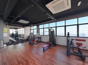 a gym with treadmills and exercise equipment in a building at Iconic Regency by BNB4U in Bayan Lepas
