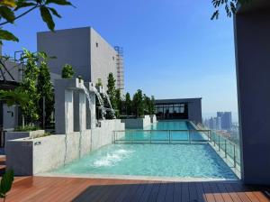 a swimming pool on the roof of a building at Iconic Regency by BNB4U in Bayan Lepas