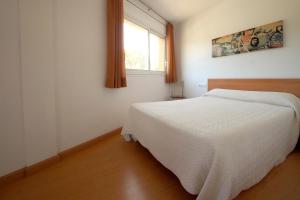Postel nebo postele na pokoji v ubytování Aparthotel Arenal