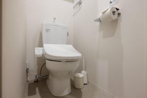 a white toilet in a bathroom with a roll of toilet paper at Reve Asakusa in Tokyo