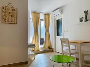 a living room with a table and a chair at Apartments Vala 2 in Grebaštica