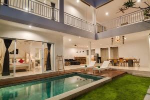 a house with a swimming pool and a living room at 3BR Villa3 Oberoi Seminyak,18Min walk to the beach in Seminyak