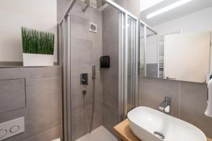 a bathroom with a shower and a white sink at Lovely Nest - Goeppingen City, Kitchen, Parking, Up to 4 People in Göppingen +40 photos