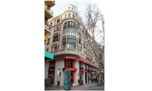 a tall building on a city street with people standing outside at Hostal Abitum Madrid in Madrid