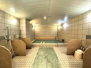 a bathroom with a bath tub in a room at Ohta Grand Hotel in Ota