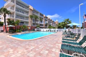 a swimming pool with lounge chairs and a hotel at Holiday Villas II in Clearwater Beach