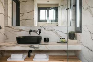 a bathroom with a black sink and a mirror at Chrysa by Vintage Travel in Lakithra +17 photos