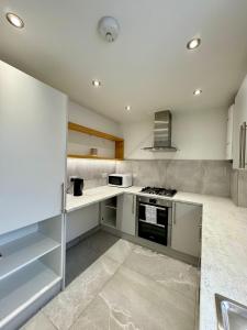 a kitchen with white counters and a stove top oven at Double Bedroom in Birmingham Near City Center in Birmingham