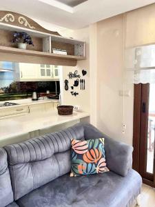 a living room with a couch and a kitchen at AyVilla 1 garden floor with garden use, sea view in Ayvalık +18 photos