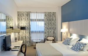 A bed or beds in a room at Hotel Nuevo Boston