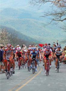 a group of people riding bikes down a road at Maison de Rêve in Notre-Dame-du-Touchet