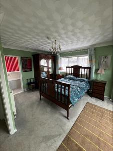 a bedroom with a bed and a coffered ceiling at Springfield oaks cottage in Newport