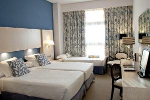 A bed or beds in a room at Hotel Nuevo Boston