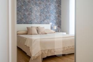 Ένα ή περισσότερα κρεβάτια σε δωμάτιο στο Homiday - Residence I Gabbiani Int 01, Livrea