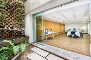 a dining room with a table and chairs and a building at Hotel Viaggio Nueve Tres in Bogotá