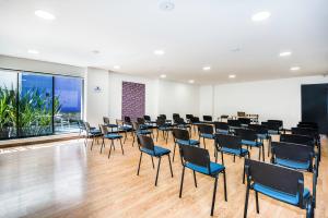 a large room with chairs and tables in it at Hotel Viaggio Nueve Tres in Bogotá