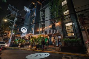 a building on a city street at night at Mad Monkey Manila in Manila
