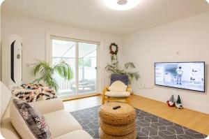 a living room with a couch and a tv at All in one Guesthouse in Incheon