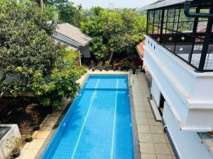 an overhead view of a swimming pool next to a building at Empire One Bedroom with Common Pool in Wayanad