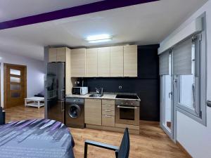 a kitchen with a refrigerator and a stove top oven at Apartamento Berria in Pamplona