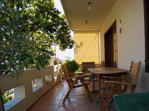 eine Terrasse mit Tisch und Stühlen und Bäumen in der Unterkunft Iliotropio Studios in Loutra Edipsou