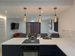 a kitchen with a counter top and a living room at Luxury Seaside Apartments with Free Parking in Blackpool