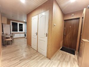 an empty room with two doors and a table at Emvika Tauragė apartment in Tauragė
